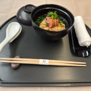 Grilled rice ball topped with spicy cod roe in a rich Japanese dashi broth