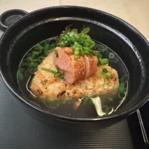 Grilled rice ball topped with spicy cod roe in a rich Japanese dashi broth